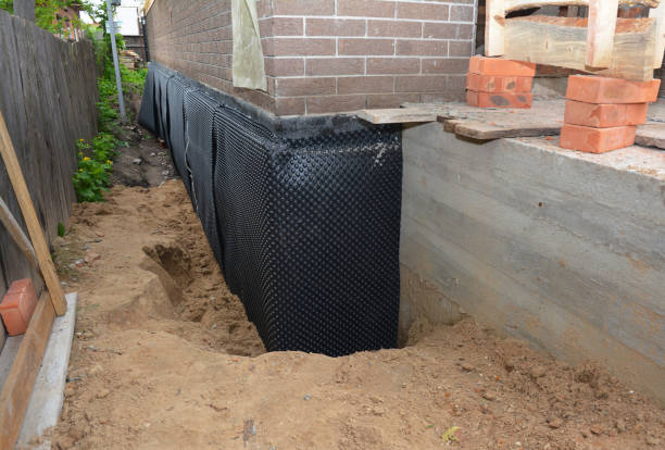 Happy homeowners after waterproofing job in Maize